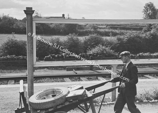 MAN WITH CART IN RAILWAY STATION